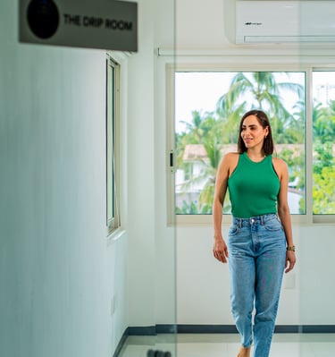 a woman in a green tank top and jeans jeans