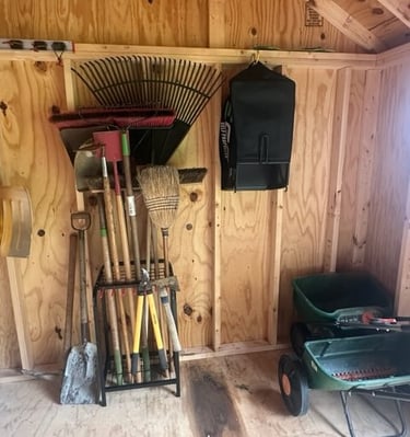 an organized shed with garden tools
