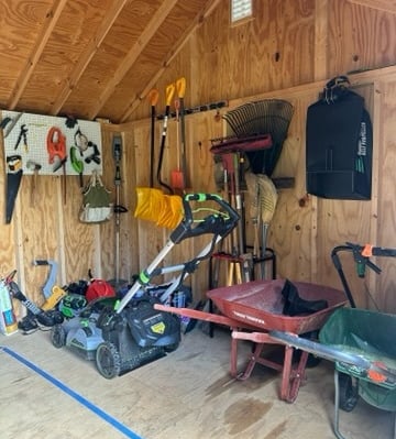 an organized shed with garden tools and equipment
