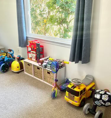 an organized playroom with ride on toys