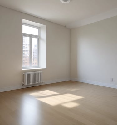 A small, old house with a rusted roof and white walls stands with a pile of gravel in front. Two men are working near the gravel, one holding a tool, and surrounded by scattered building materials. A large tree with green leaves is on the left side.