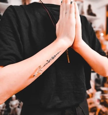 a person with a traditional thai tattoo sak yant on his arm