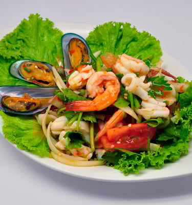 Spicy mixed seafood salad on white plate