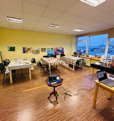 a art therapy room with paintings and a laptop on a table
