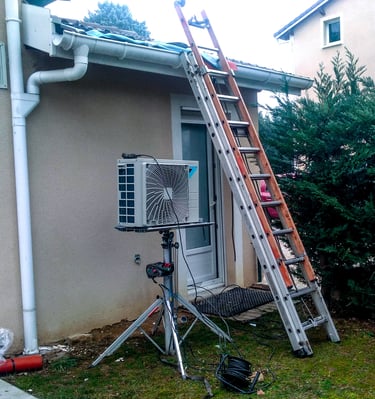Lifting an air conditioning outdoor unit onto a roof.