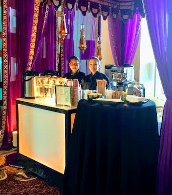 a man standing in front of a table with a table cloth