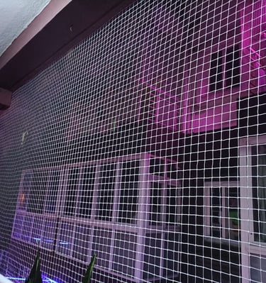 Close-up of a sturdy safety net installed on a balcony to protect pets.