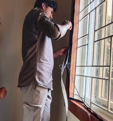 A series of sarja windows covered with sleek white mosquito nets, blending seamlessly with the build