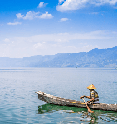 a man in a hat and a hat on a boat - SEMATA INDONESIA Program