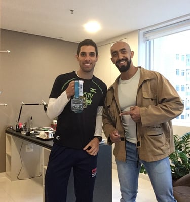 two men standing next to each other in a room