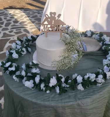 wedding cake on a table on the beach