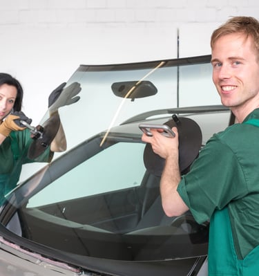 a man and woman in green overalls and gloves are standing in front of a