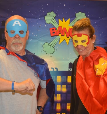 camp directors in their super hero outfits