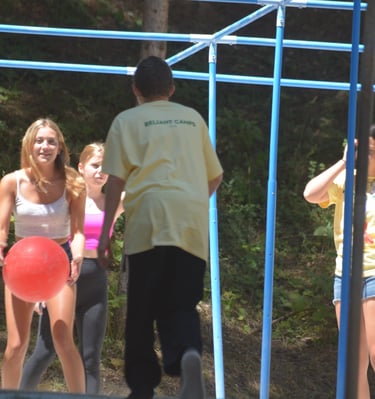 a group of people playing 9-square in the air
