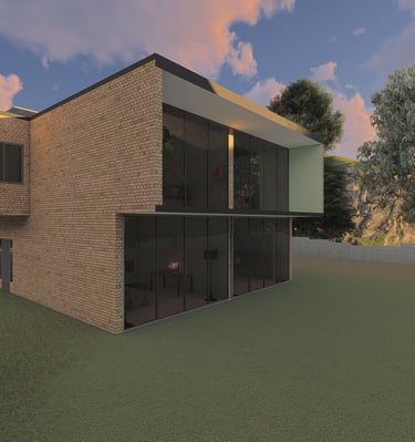 Modern two-story brick house with large glass windows and a green lawn at sunset.