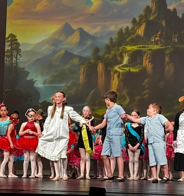 a group of children and adults in costume on stage