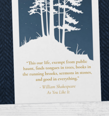 Close up of the forest themed binder detailing the Shakespeare nature quote.