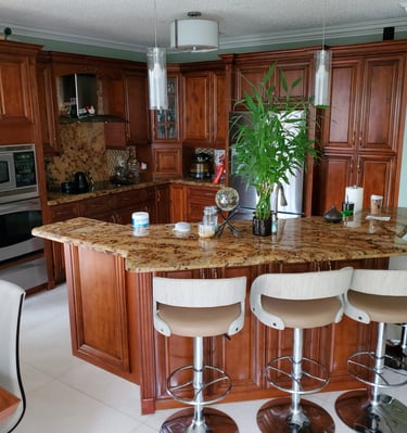 a kitchen with a large island and a bar stool