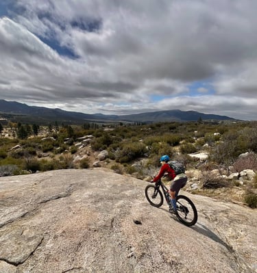 a person riding a bike on a rocky surface