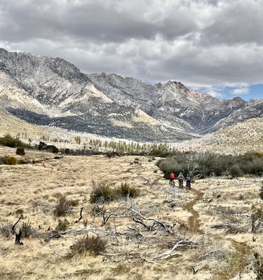 a group of people riding bikes on a trail