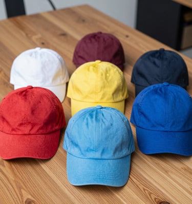 A white sneaker is placed on a perforated metal surface, with the edge of the surface showing some rust. The color of the metal appears worn and the surface has a grid of circular holes. The background is a dark green color, possibly water.