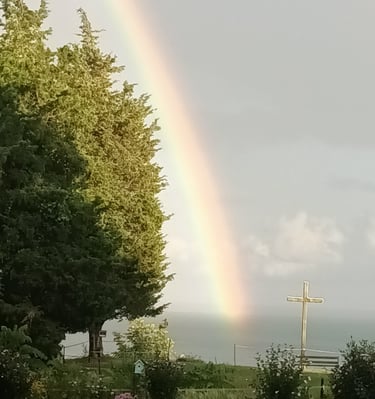 a rainbow and the cross at camp