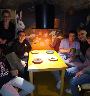 a group of people sitting around a table with a table with a table cloth