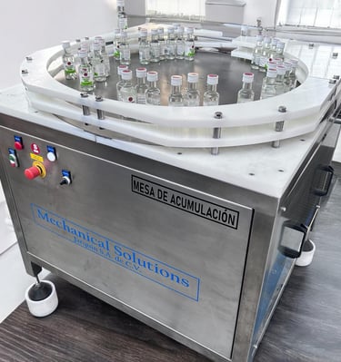 mesas de acumulacion, buffer de linea, zona de empacado de botellas