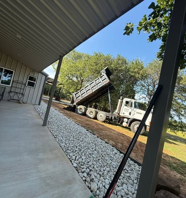 a dump truck dumping dirt