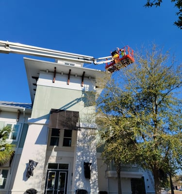 rofessional exterior high-rise painting using lift equipment by Garnet Painting & Remodeling in Douglas, GA.