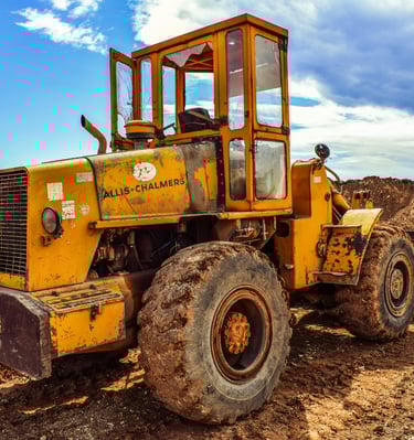 Demolition works-TLB carring rubble from an old building to the dumping site in spring-field, durban