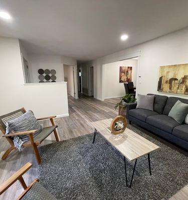 home remodelliving room with white painted walls, refinished light colored wood floors 