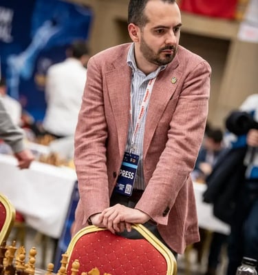 Chess journalist Vlad Ghita watching a game closely at the European Championship 2025 in Eforie Nord