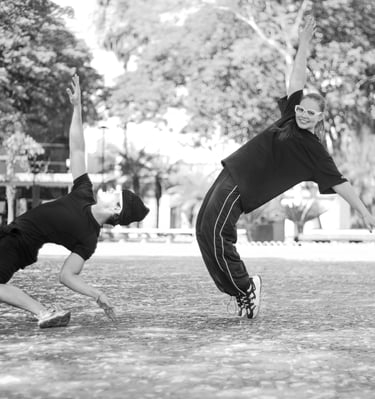 a man and a woman playing baseball in a park