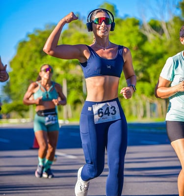 a woman running in a race with a headphones on