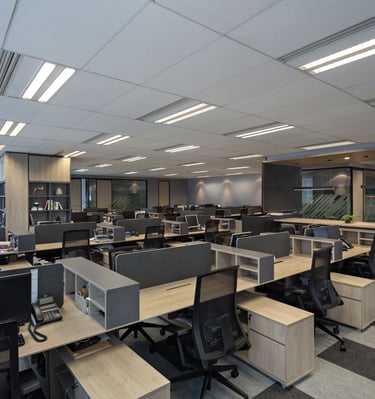 a large open office with a lot of desks and chairs