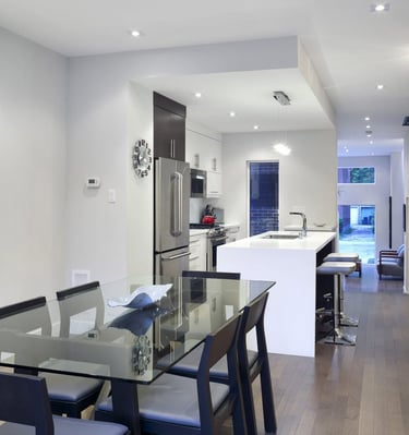 a kitchen with a table and chairs and a glass table