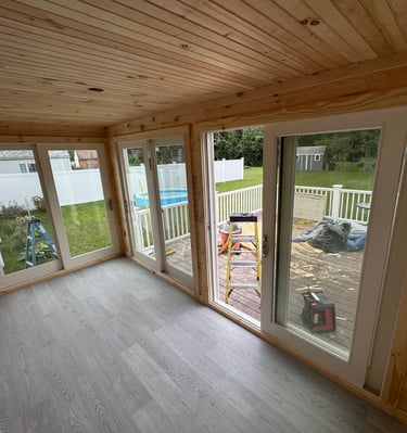 a room with a sliding glass door and a pool