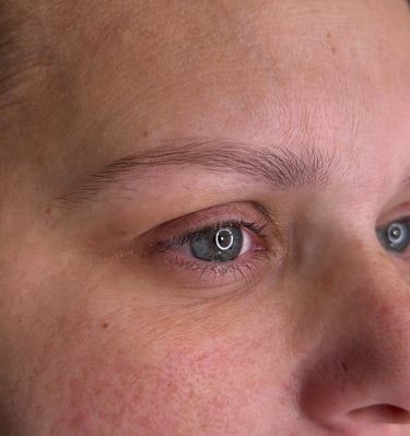 A woman with her current state of eyebrows before getting microblading procedure