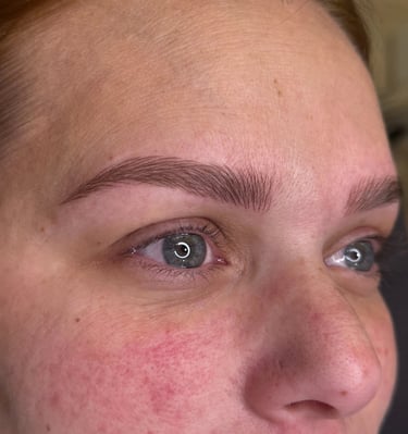 Woman after microblading was done showcasing her natural looking eyebrows