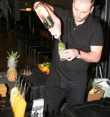 Master bartender pouring mixed drinks