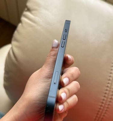 a person holding a cell phone in their hand