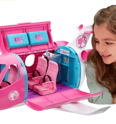 a girl is playing with a pink toy airplane