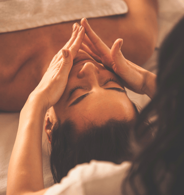 a woman having a facial massage in a beauty salon