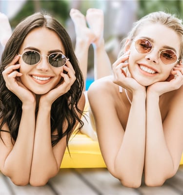 Two women relaxing on a pool float during a sunny Pool Party Crawl daylife experience