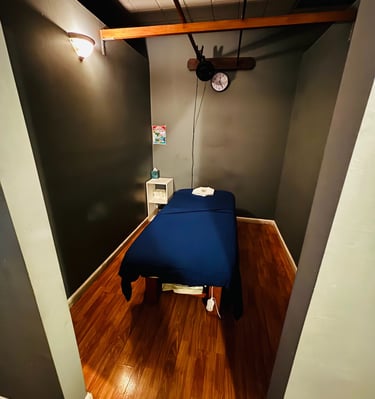 a bed in a room with a blue bed and a clock