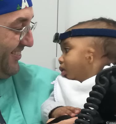 a man in a blue shirt and a baby in a blue hat