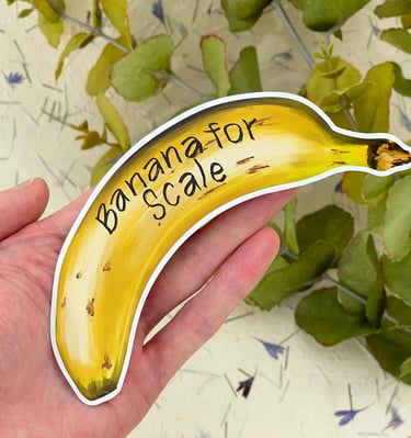 A banana sticker with banana for scale written on it