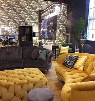 a living room with sofas and a large window