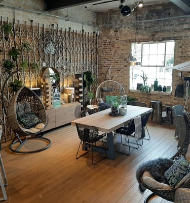 a garden room with a table and chairs and accessories